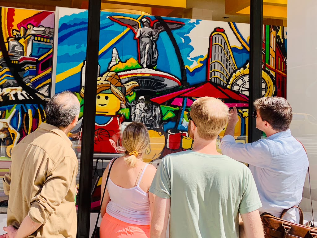 Guests exploring the LEGO NYC mural on the Flatiron Family Tour